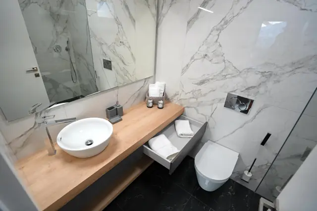 Marble bathroom with oak vanity and towel drawer