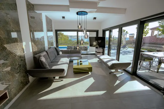 Sunlit living room opening onto the pool terrace