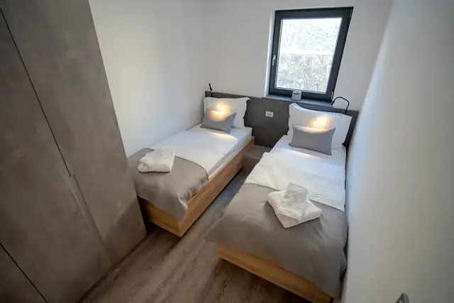 Second twin bedroom with garden-facing window