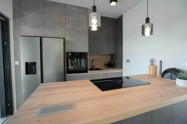 Designer kitchen with concrete-grey cabinetry and island