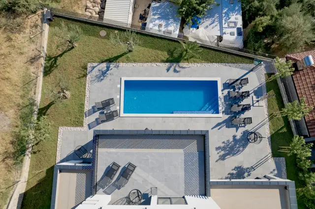 Aerial view of the pool deck, sun loungers and olive garden