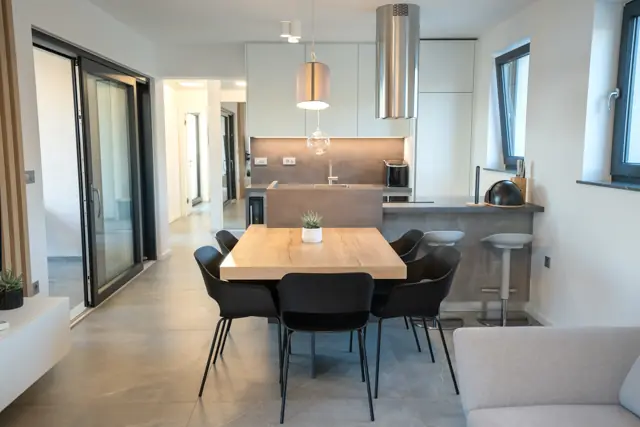 Dining table and breakfast bar in the upper-floor kitchen