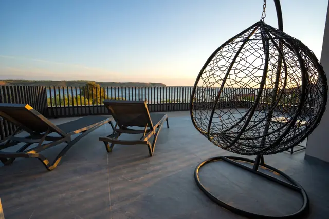 Sunset on the upper terrace with hanging chair and sea view