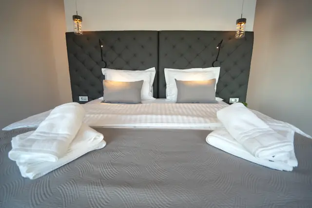 Close-up of a made-up double bed with fresh towels