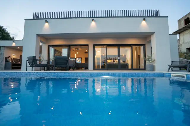 Water-level view across the illuminated private pool