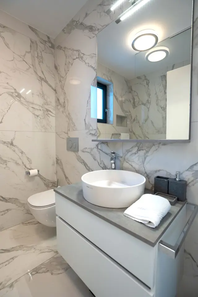Marble bathroom with white vanity and round vessel basin