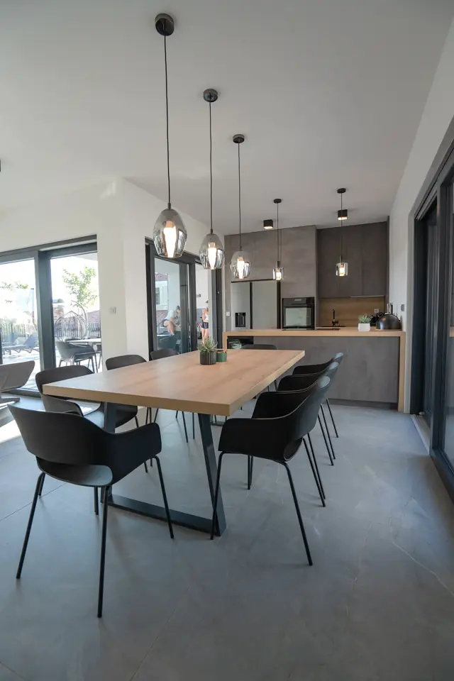 Open-plan dining area with pendant lights and kitchen