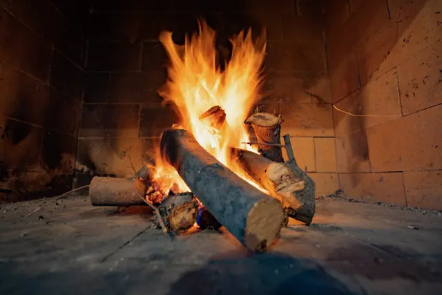 Open fire burning in the outdoor fireplace
